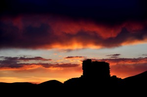 The spectacular sunset silhouettes the tallest wall on the Wupatki Pueblo. 