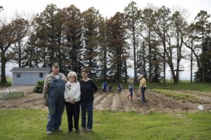 Lois Spiering with son Kelly and daughter-in-law Sylvia, the daughters planting the garden. 