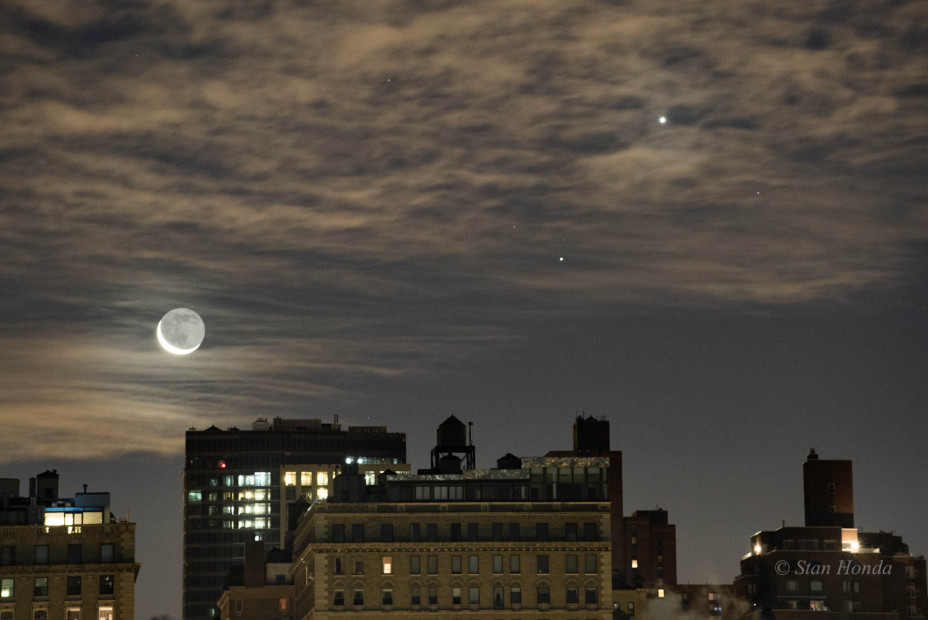 Jan. 7, 2016: A crescent moon, Saturn and Venus rise above rooftops. A crystal clear atmosphere allows us to see "earthshine" on the unlit portion of the moon.