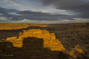 The last rays of the sun on a Peñasco wall and the canyon mesa beyond. 